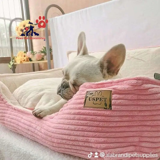 French Bulldog snoozing on a pink corduroy pet bed, perfect for smart pet feeders.
